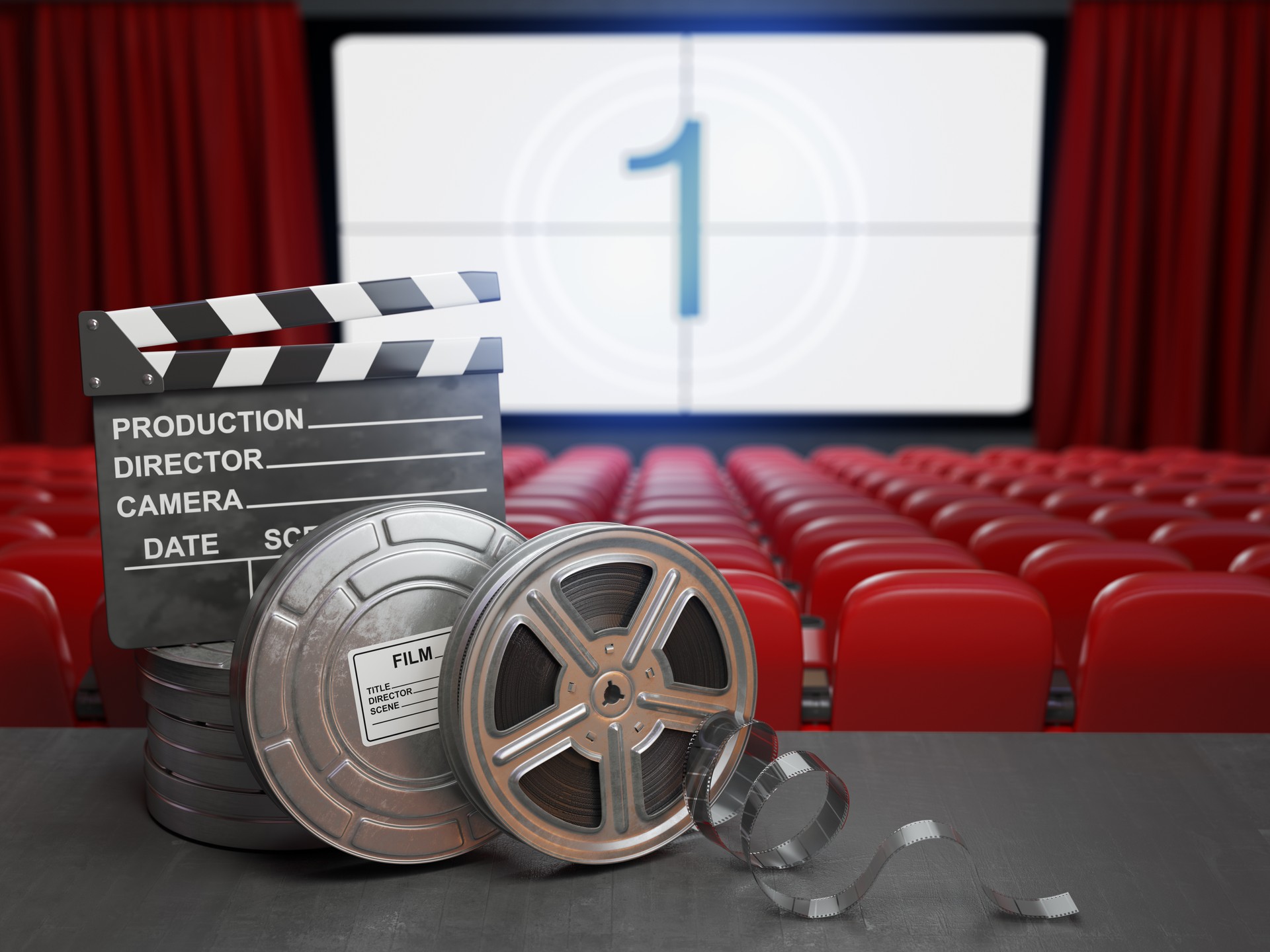 Cinema, movie or home video concept background. Film reels and clapper board in the theater movie cinema screen with empty seats.